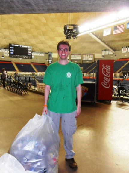 EcoHouse volunteer collecting leftover recyclables after the game.