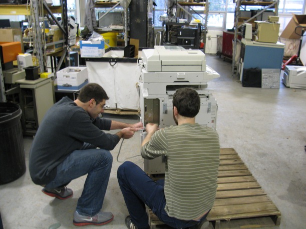 Surplus Student Employees preparing a copier for recycling